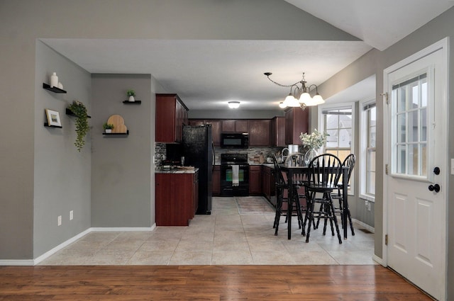 dining space with light wood-type flooring and a notable chandelier