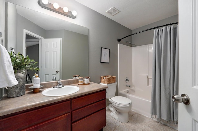 full bathroom with tile patterned floors, shower / tub combo with curtain, vanity, and toilet