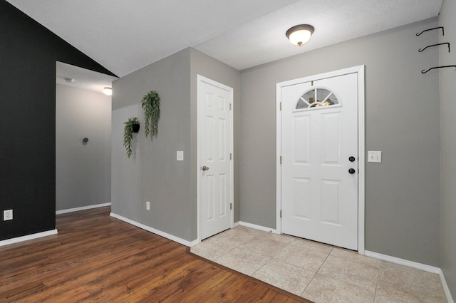 foyer entrance featuring hardwood / wood-style floors and lofted ceiling