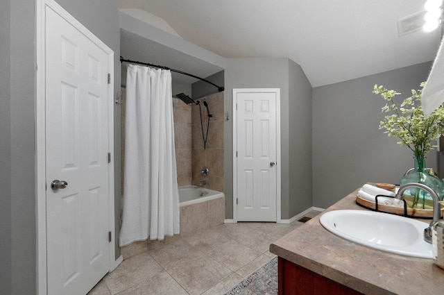 bathroom featuring tile patterned flooring, shower / bath combo, and vanity