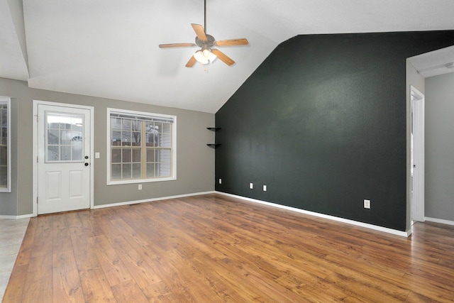 interior space featuring wood-type flooring, vaulted ceiling, and ceiling fan