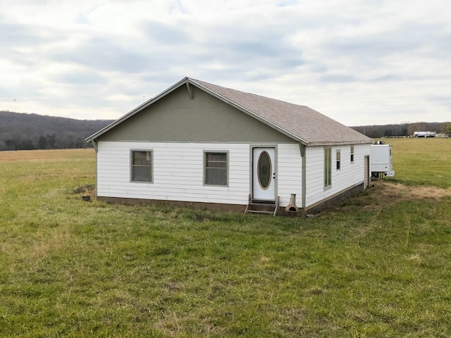 rear view of property with a lawn