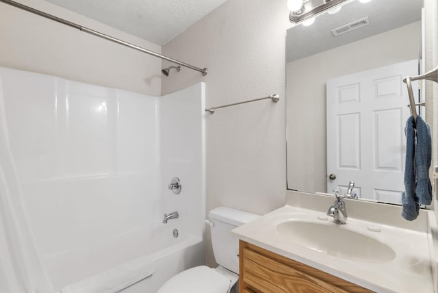 full bathroom featuring vanity, toilet, washtub / shower combination, and a textured ceiling