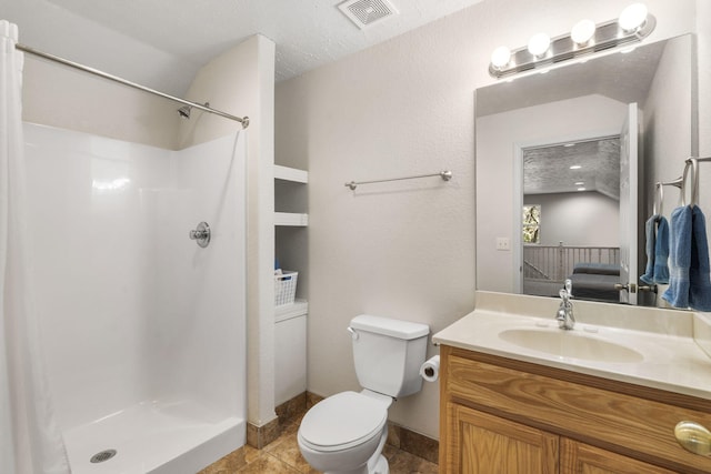 bathroom with a shower with shower curtain, vanity, a textured ceiling, and toilet