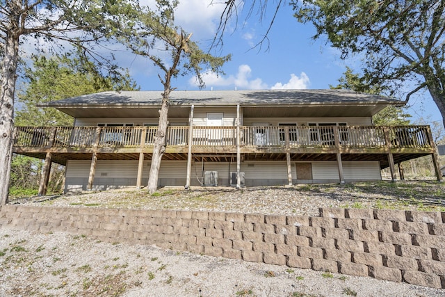 rear view of house with a wooden deck