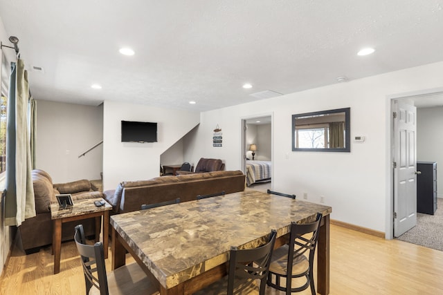 dining space with light wood-type flooring