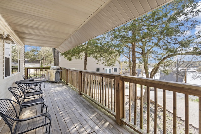 wooden deck featuring a grill