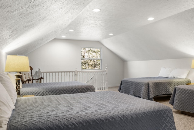 bedroom featuring vaulted ceiling, carpet floors, and a textured ceiling