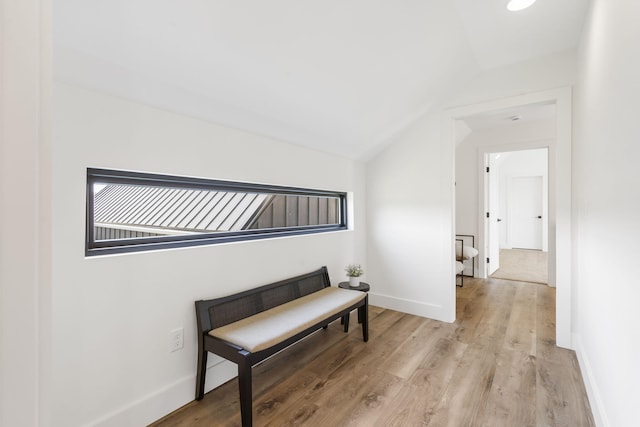 sitting room featuring light hardwood / wood-style flooring and lofted ceiling