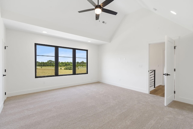 carpeted empty room featuring high vaulted ceiling and ceiling fan