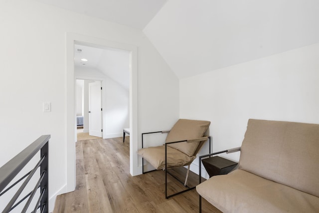 sitting room featuring light hardwood / wood-style flooring and lofted ceiling