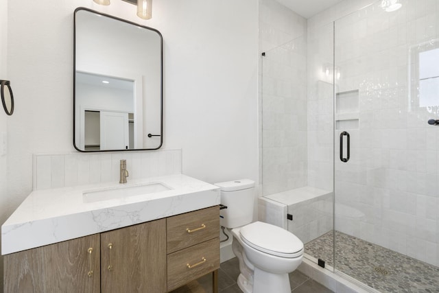 bathroom featuring walk in shower, vanity, and toilet