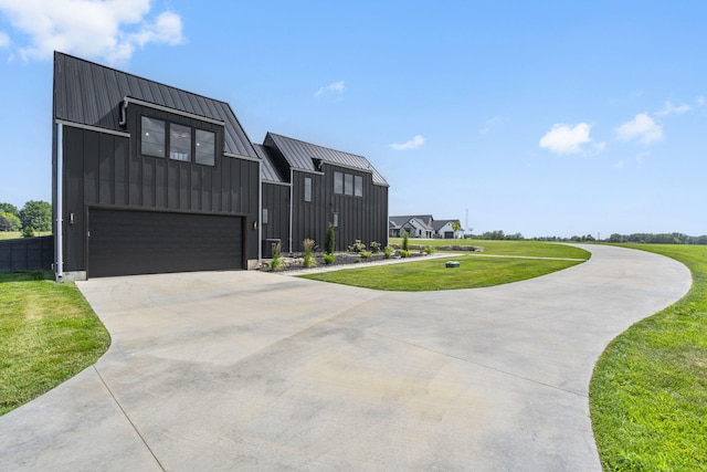 view of front of home with a front yard and a garage