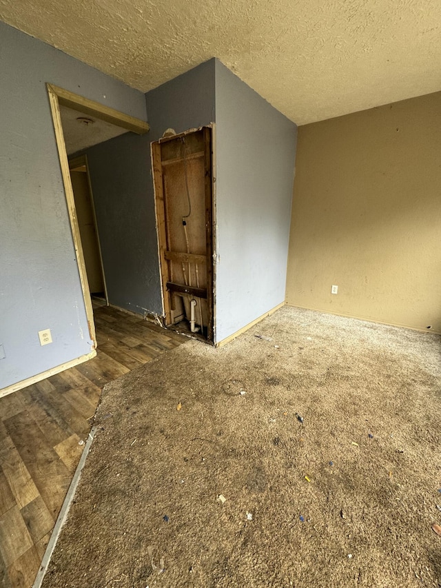 unfurnished room featuring a textured ceiling