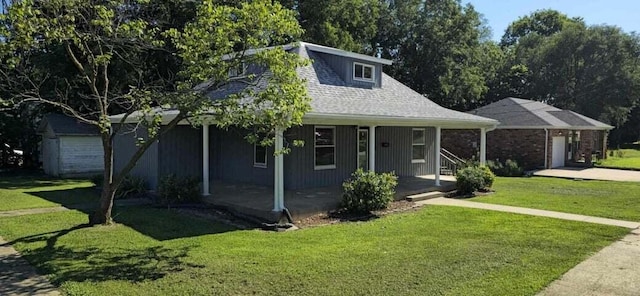 view of front facade with a front yard, a porch, and a garage