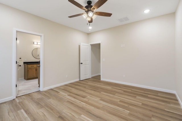 unfurnished bedroom featuring connected bathroom, ceiling fan, and light hardwood / wood-style flooring