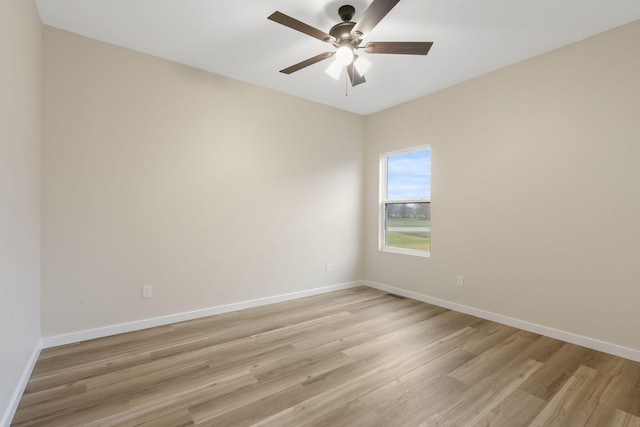 empty room with ceiling fan and light wood-type flooring