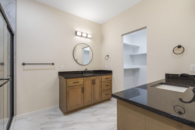 bathroom with vanity and a shower with shower door