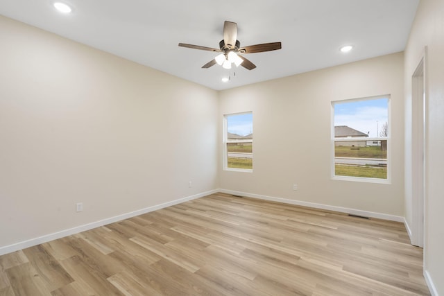 spare room featuring ceiling fan and light wood-type flooring