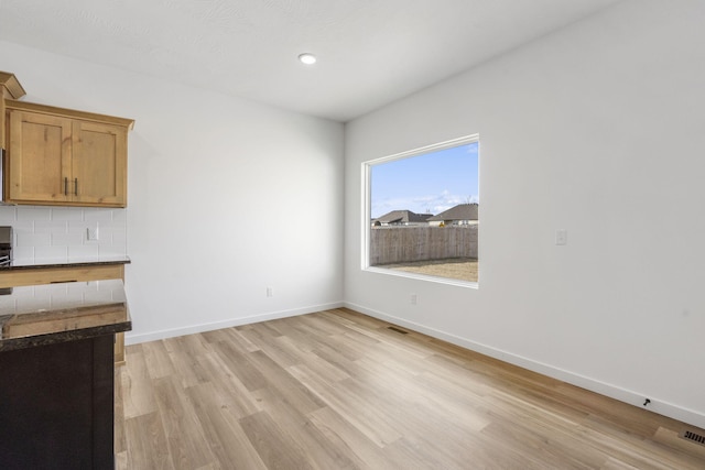 unfurnished dining area featuring light hardwood / wood-style floors