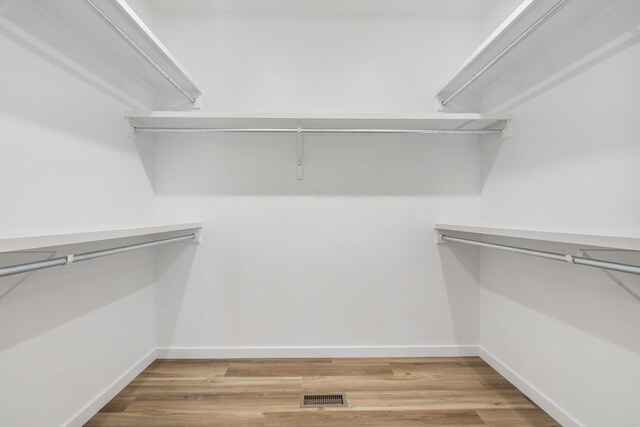 spacious closet featuring hardwood / wood-style floors