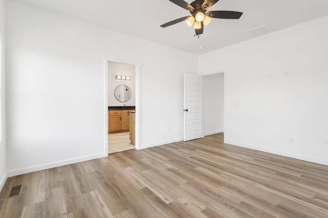 unfurnished bedroom featuring ceiling fan, connected bathroom, and light hardwood / wood-style floors