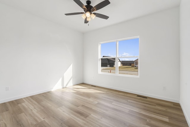 unfurnished room featuring ceiling fan and light wood-type flooring