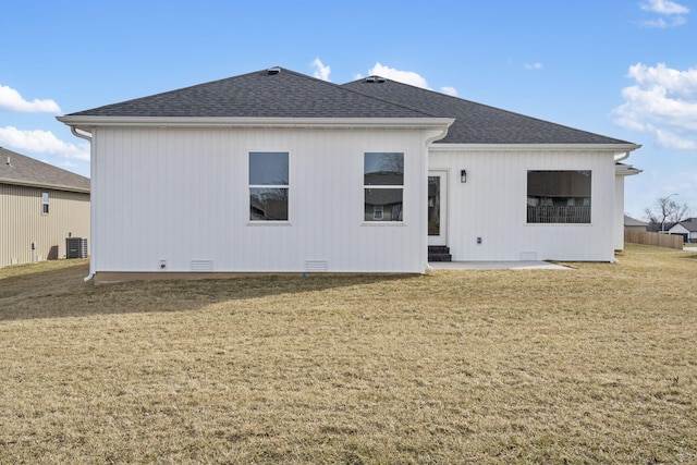 back of house featuring cooling unit, a yard, and a patio