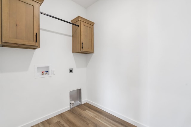 clothes washing area with washer hookup, wood-type flooring, cabinets, and hookup for an electric dryer