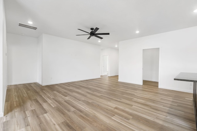 unfurnished living room featuring ceiling fan and light wood-type flooring