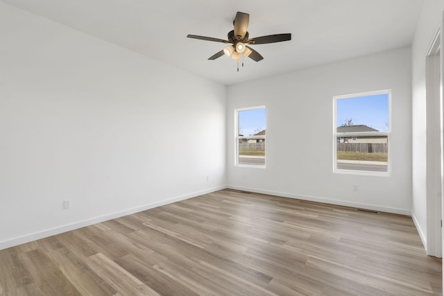 empty room with light hardwood / wood-style floors and ceiling fan