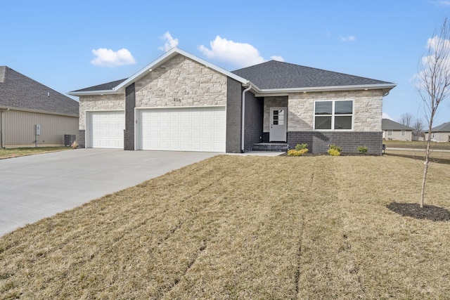 view of front of property featuring a garage, central AC, and a front lawn