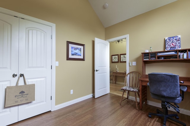 office with hardwood / wood-style floors and vaulted ceiling