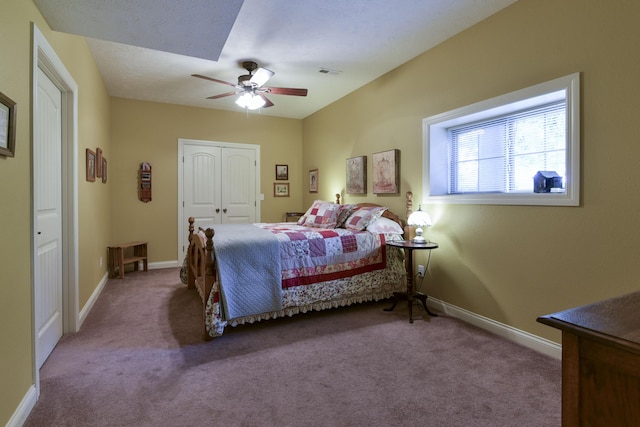 carpeted bedroom with ceiling fan and a closet