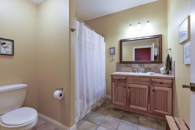 bathroom featuring vanity, backsplash, toilet, and tile patterned flooring