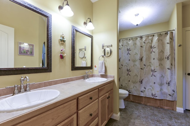 full bathroom with shower / bath combo, toilet, a textured ceiling, and vanity