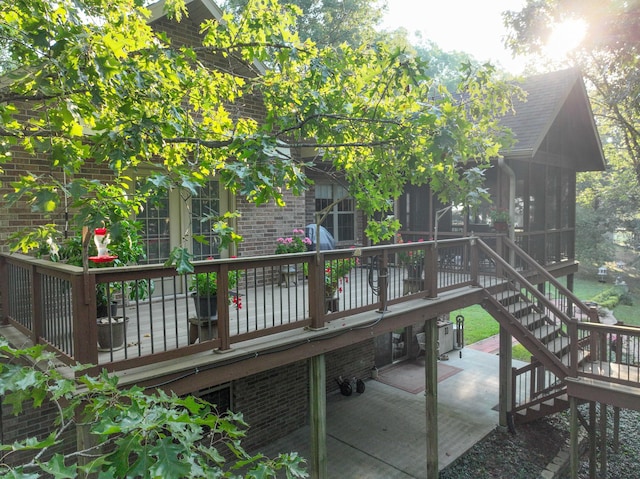 wooden terrace with a patio area and a sunroom