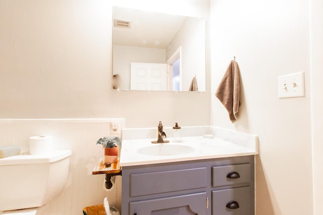 bathroom featuring vanity and toilet