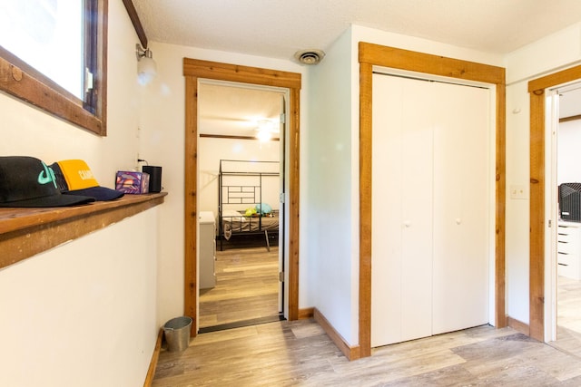 corridor with light hardwood / wood-style flooring