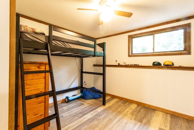 unfurnished bedroom with a textured ceiling, light hardwood / wood-style floors, and ceiling fan