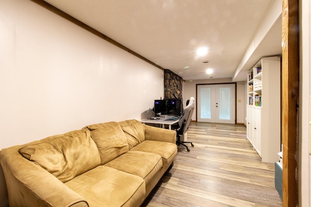 living room with french doors and light wood-type flooring