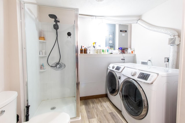 washroom with light hardwood / wood-style floors and washing machine and clothes dryer