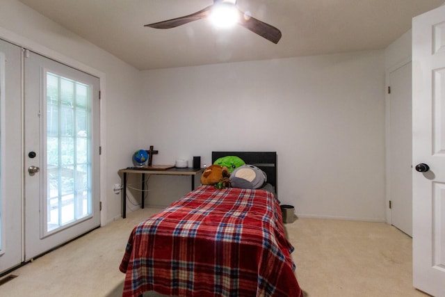 bedroom with access to outside, ceiling fan, and light carpet