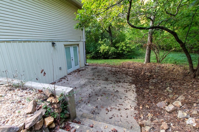 view of yard featuring a patio area and french doors