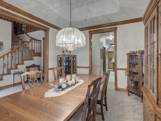 dining room featuring a notable chandelier, ornamental molding, and light carpet