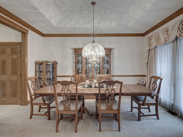 carpeted dining area with a tray ceiling and a notable chandelier