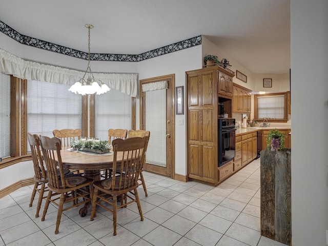 dining area with light tile patterned floors and a notable chandelier