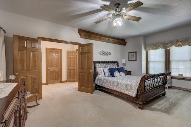 carpeted bedroom with a textured ceiling and ceiling fan