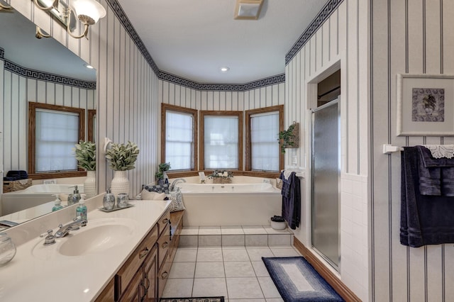 bathroom featuring tile patterned floors, vanity, and shower with separate bathtub