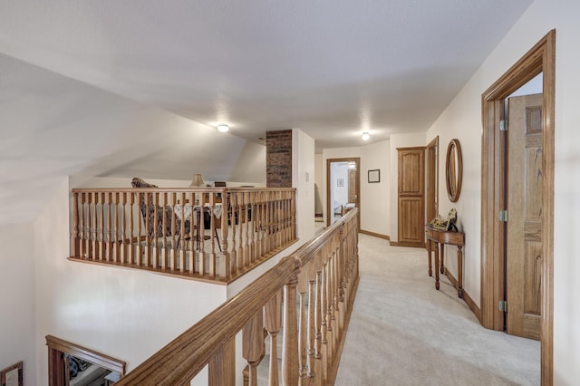 hallway with light colored carpet